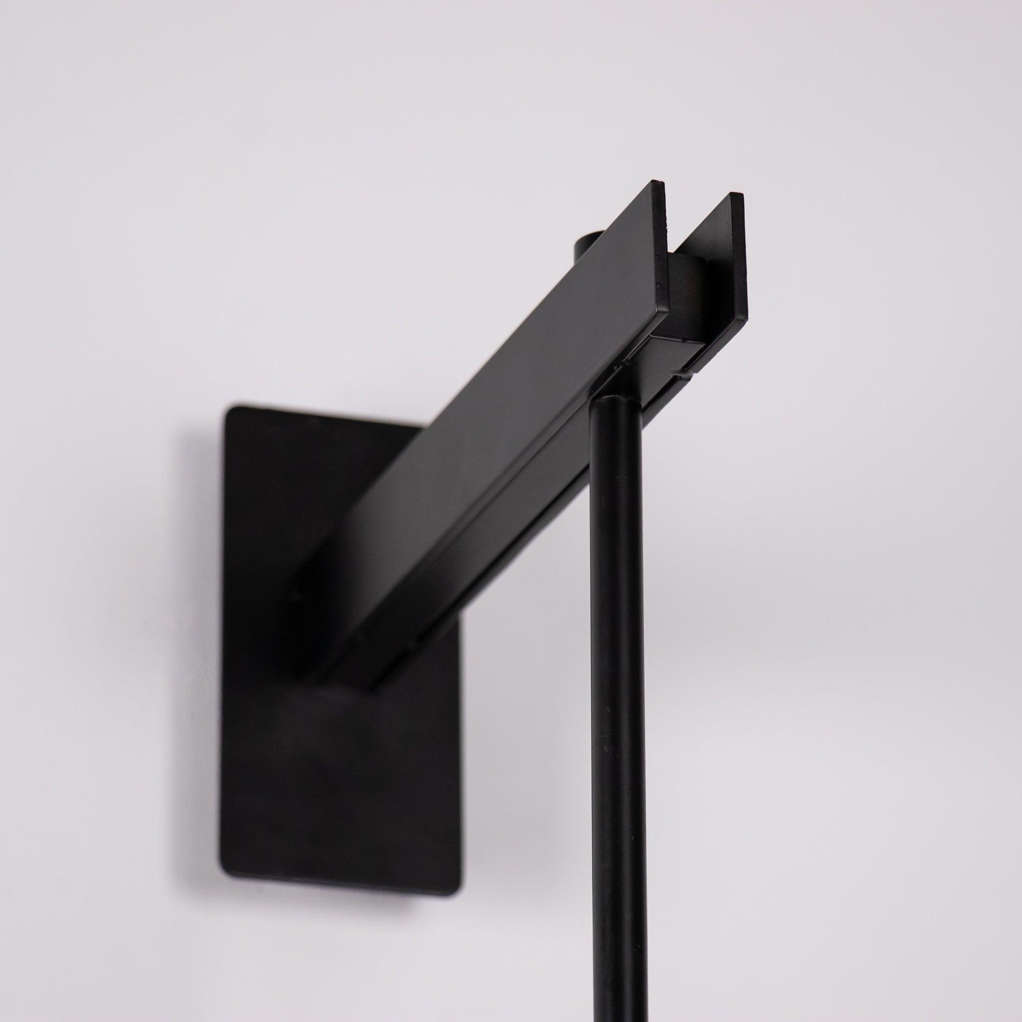 Angled close-up of Black Vadim upper wall arm and rectangular backplate on pale background
