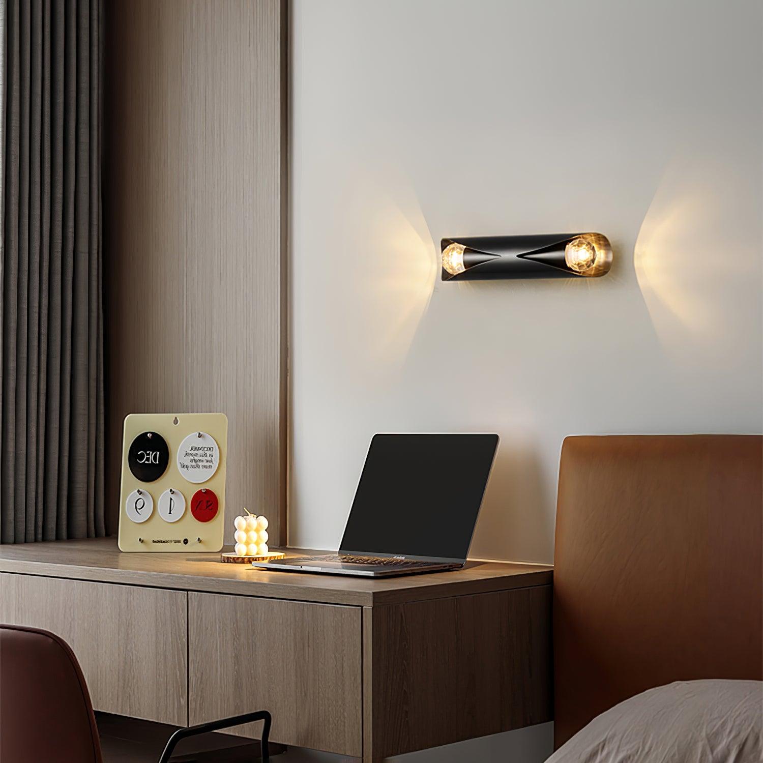 Black wall lamp mounted horizontally above a desk