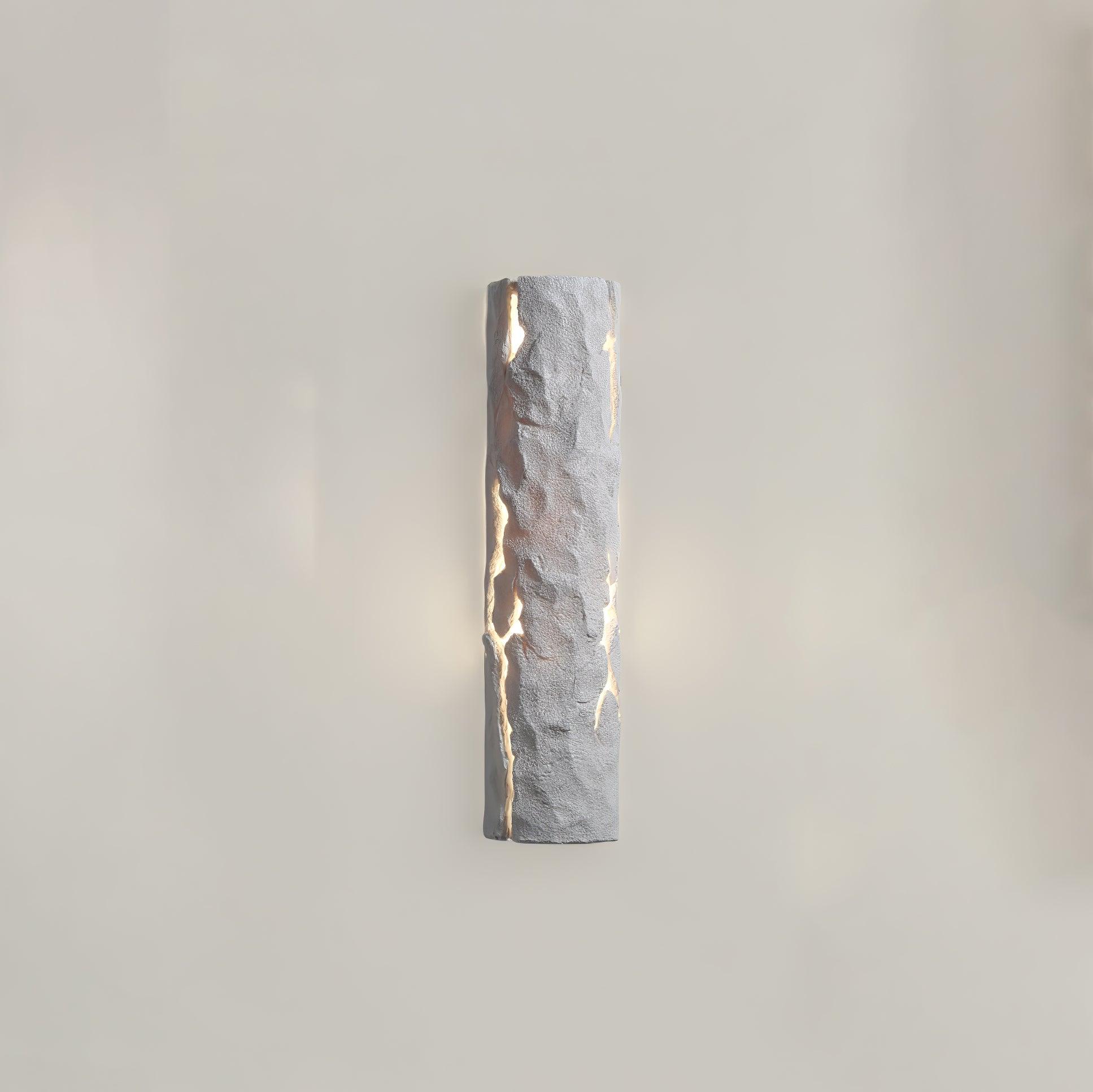 White Broken Bark wall light lit on grey wall, with rough curved face and branching luminous openings