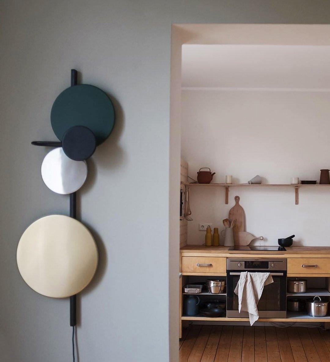 Unlit blue disc fixture beside a dining area