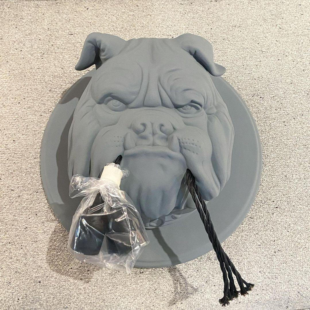 Grey bulldog lamp resting on a textured surface