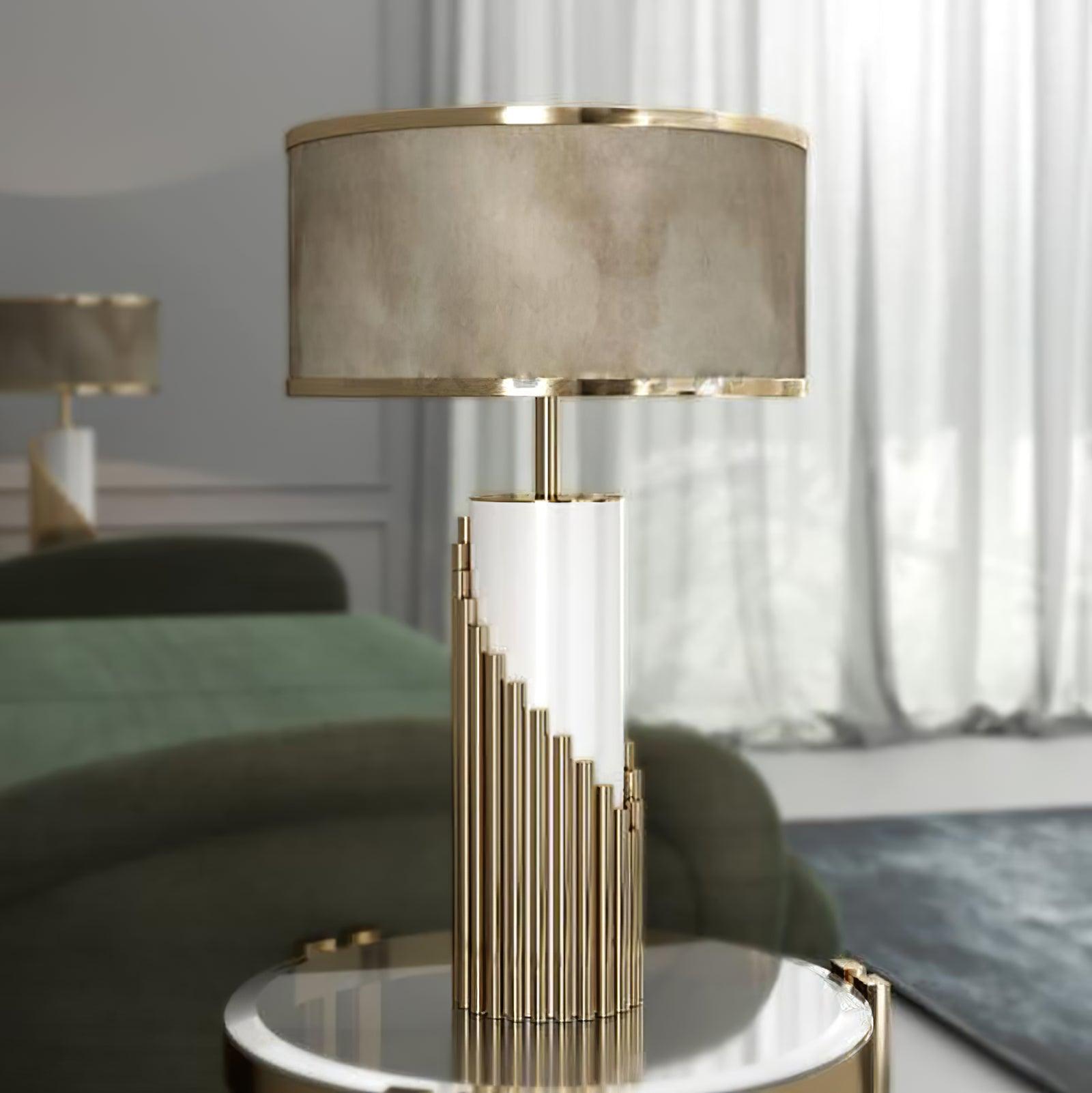 Streamline Gold lamp beside a green sofa and pale curtains