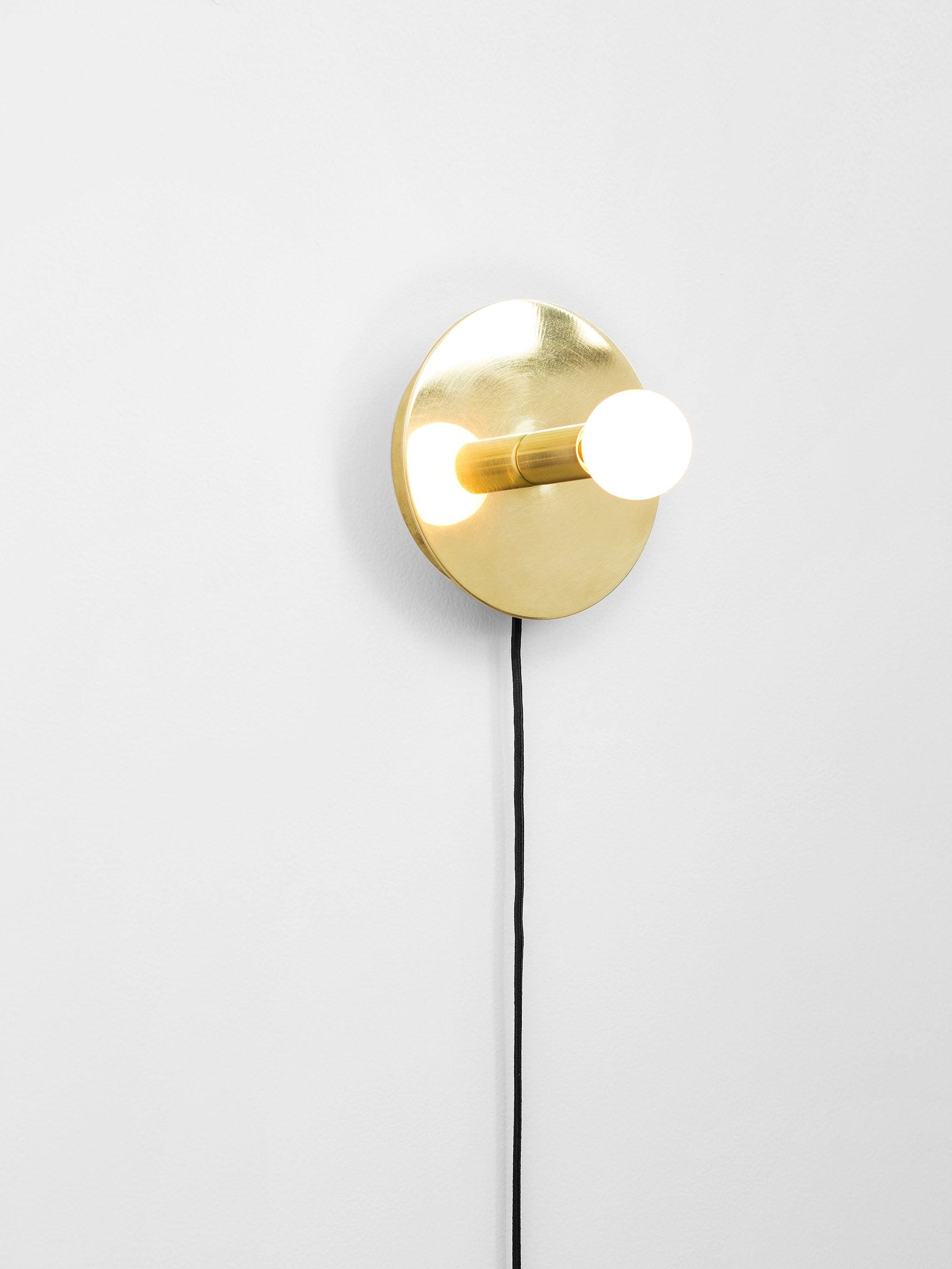 Round disc wall lamp with hanging cord