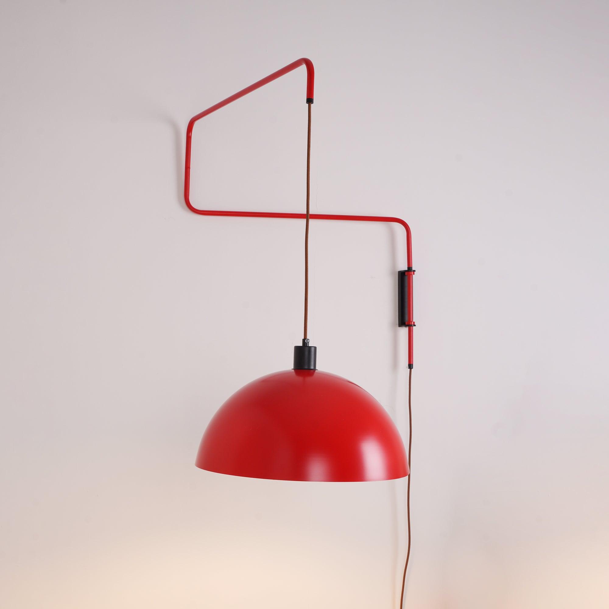 Red angular arm with suspended hemispherical shade