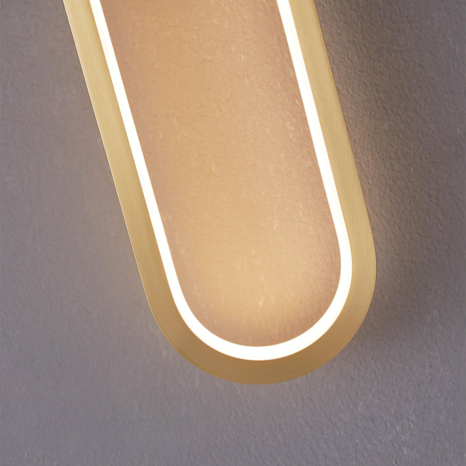Close-up of the lower gold-coloured curve and white illuminated strip around the oval loop
