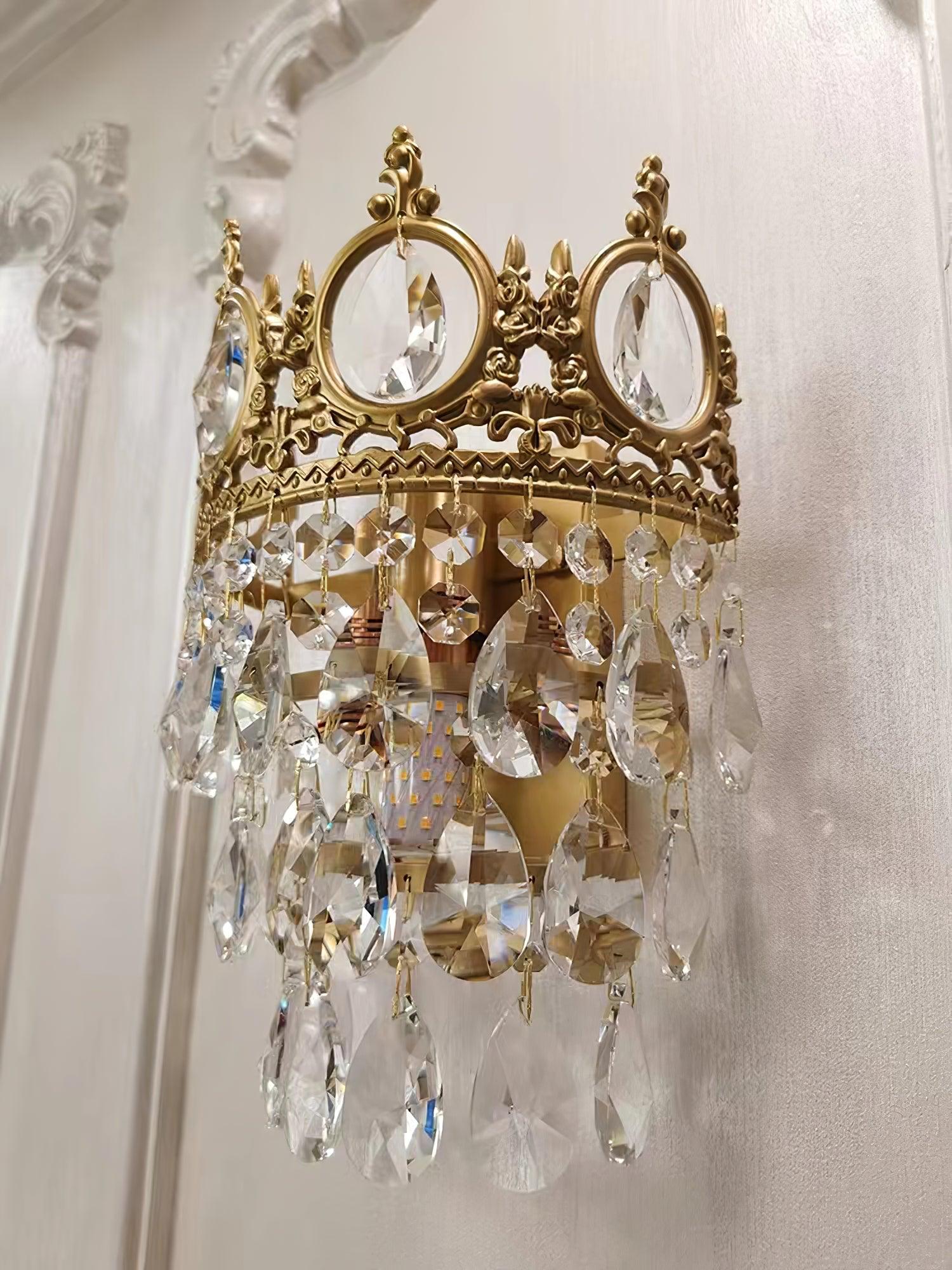 Angled crystal wall light beneath decorative moulding