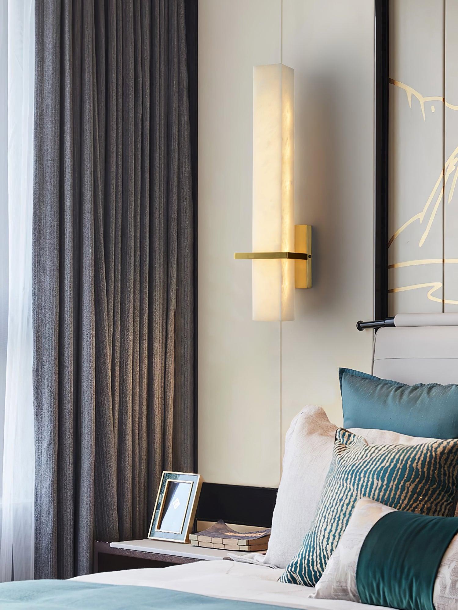 Vertical alabaster sconce in a bedroom