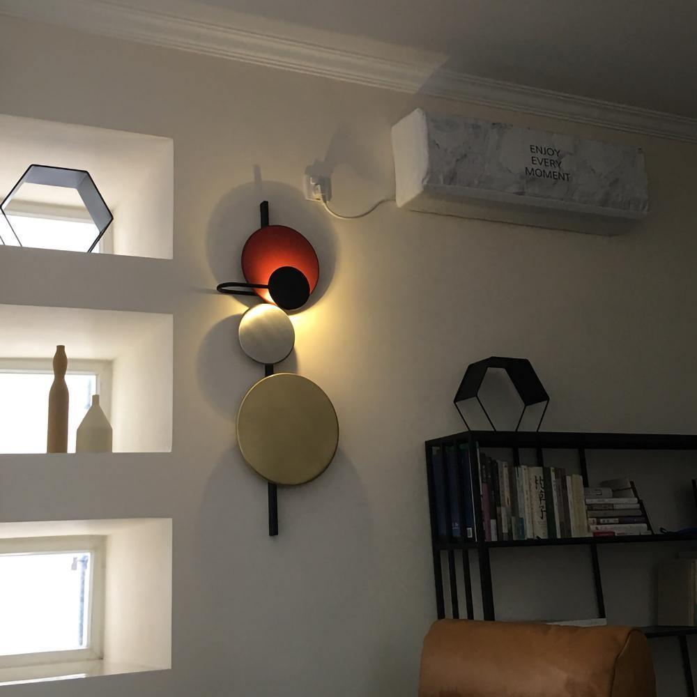 Red disc fixture above indoor shelving