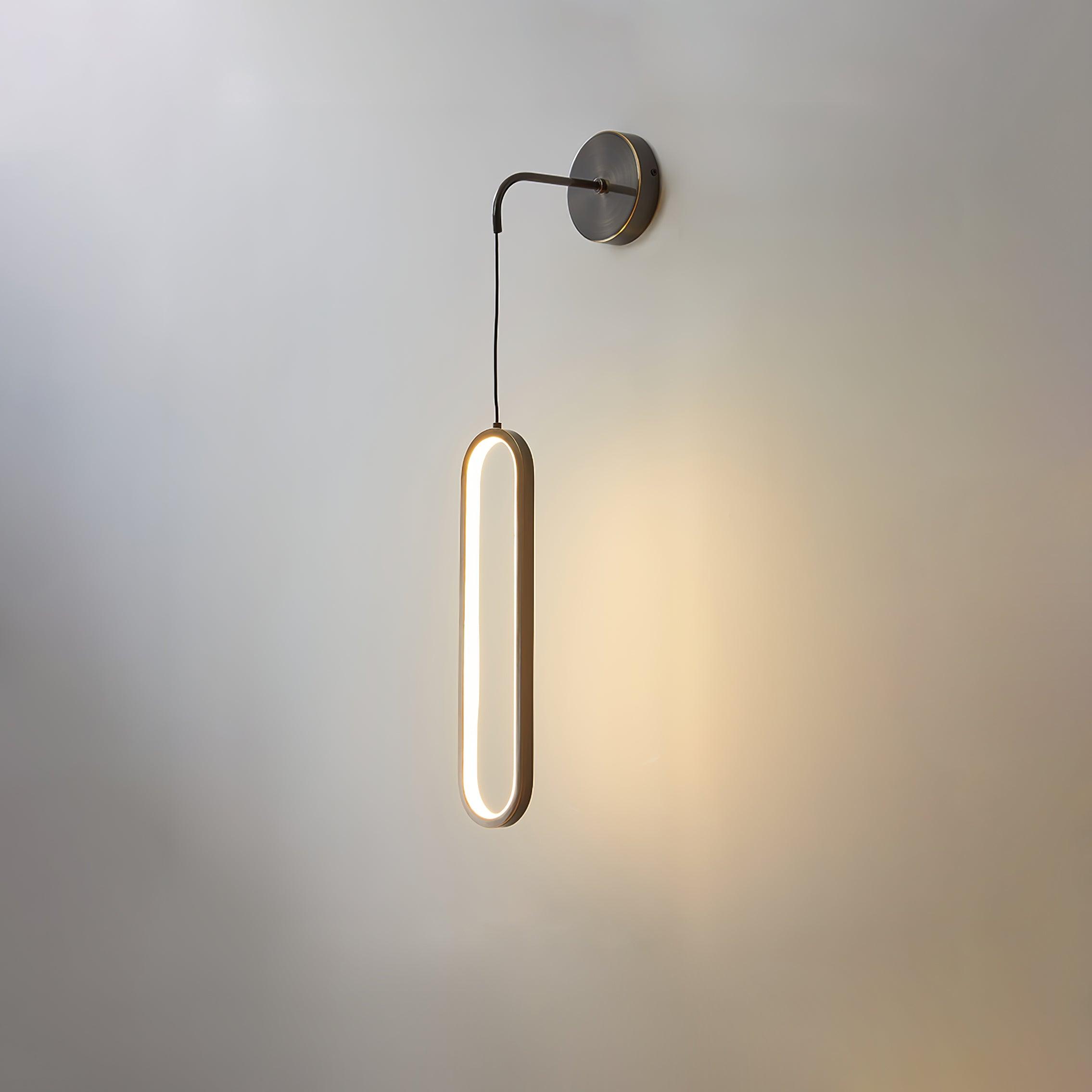 Black-option oval light against a pale wall