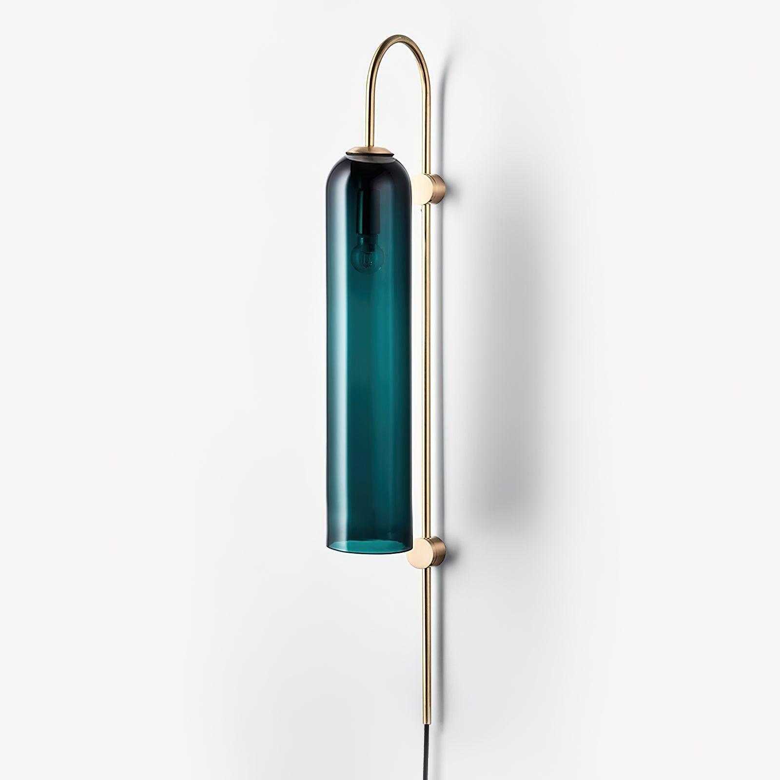 Dark glass tube beside a pale wall