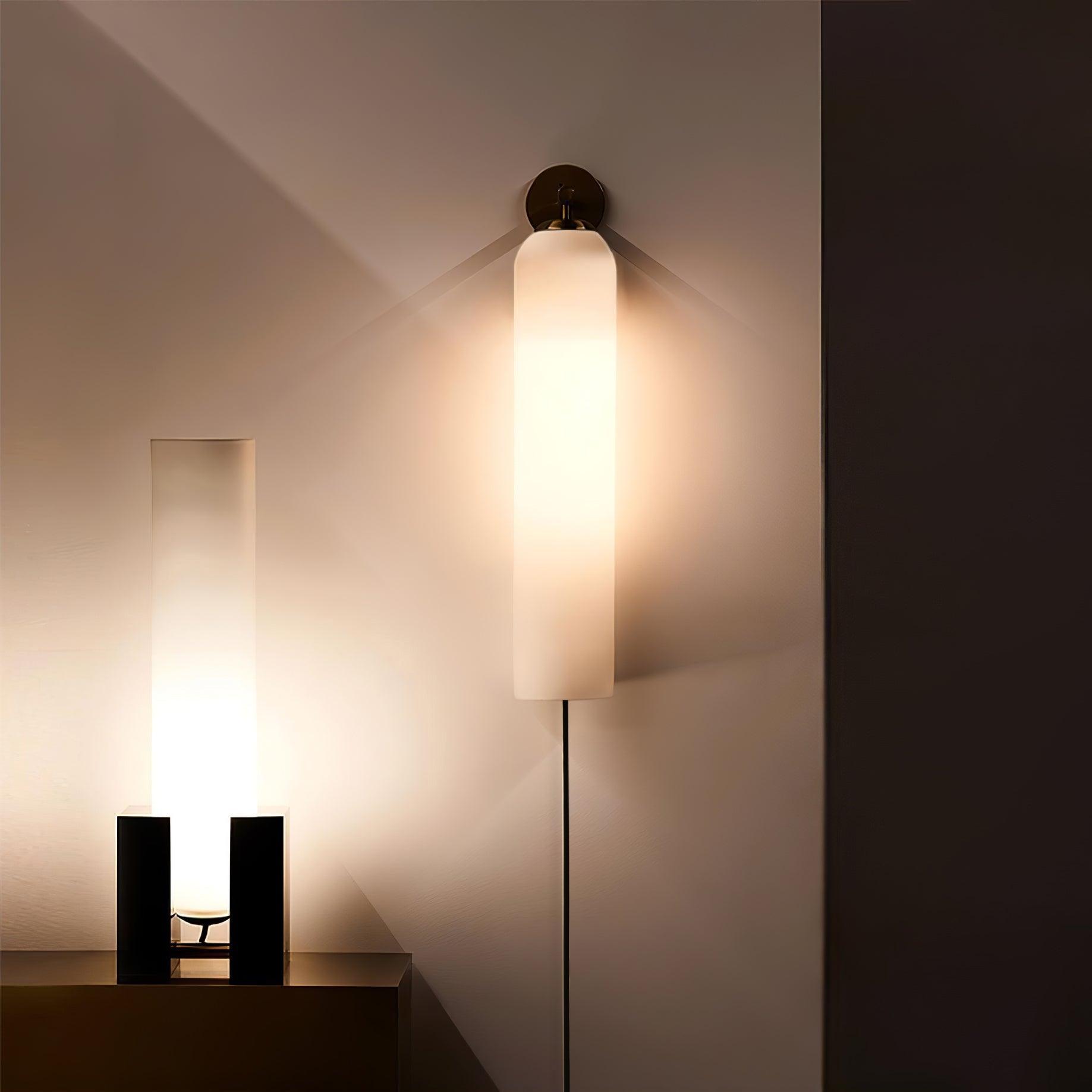White-glass sconce above a sideboard