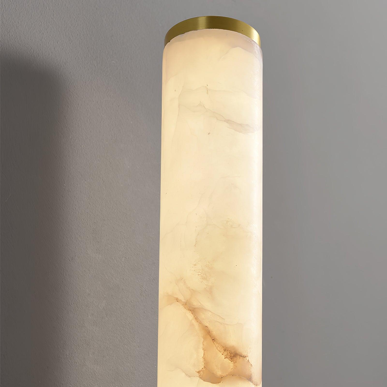 Close-up of illuminated stone veining and brass end cap