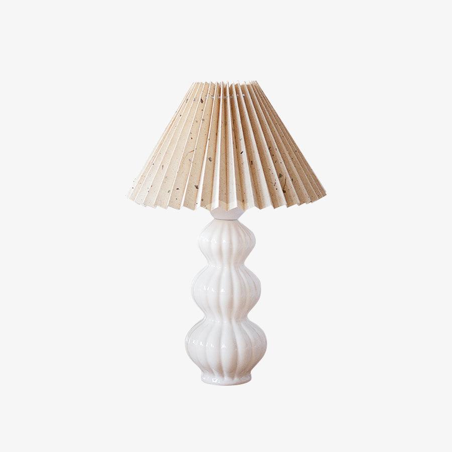 Leo lamp with pale patterned shade on a white background