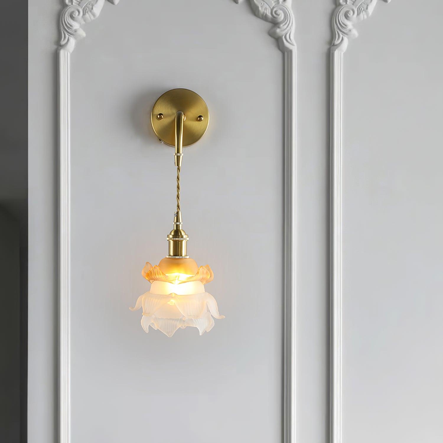 Front view of the Laura wall lamp on a panelled wall