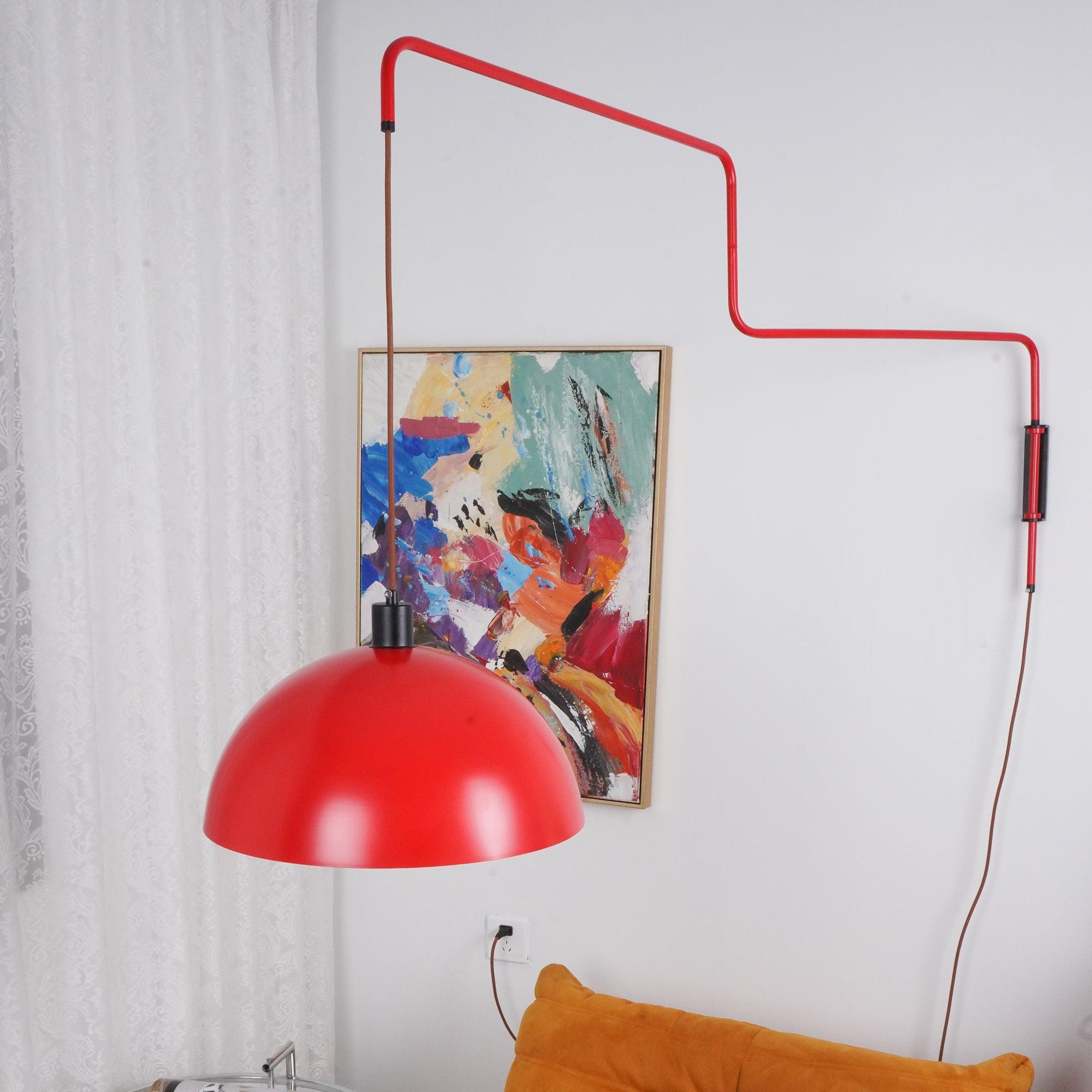 Red hemispherical shade hanging in front of wall art