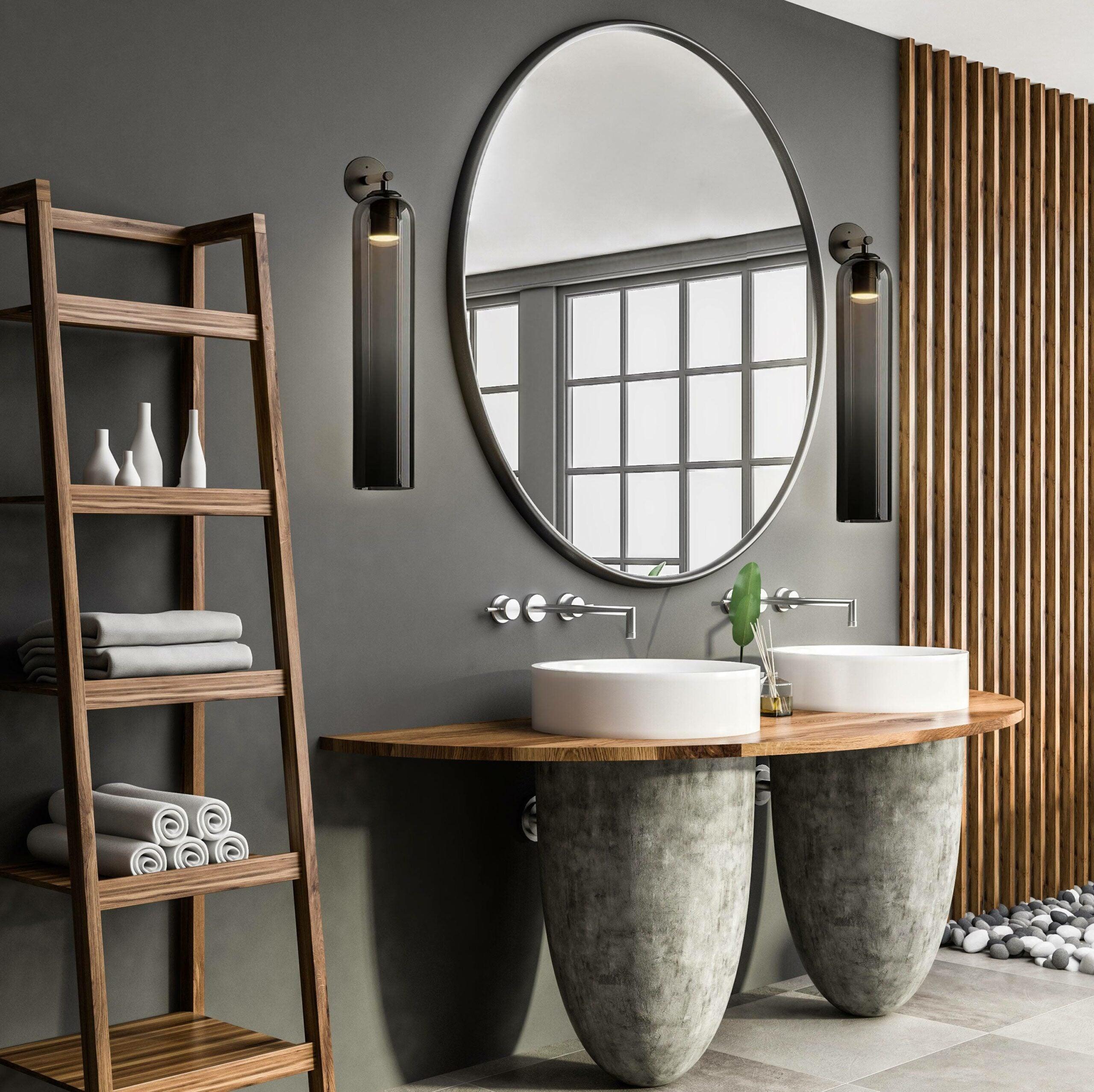 Two glass sconces beside a bathroom mirror