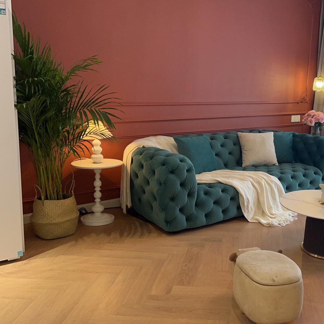 Leo table lamp in a living room beside a teal sofa