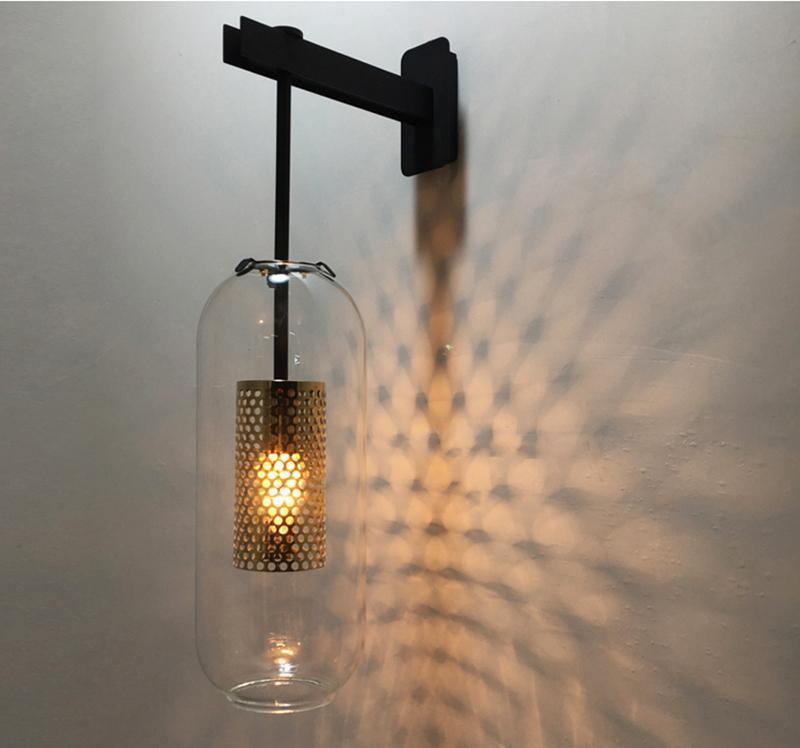 Black wall fixture with a glowing perforated cylinder