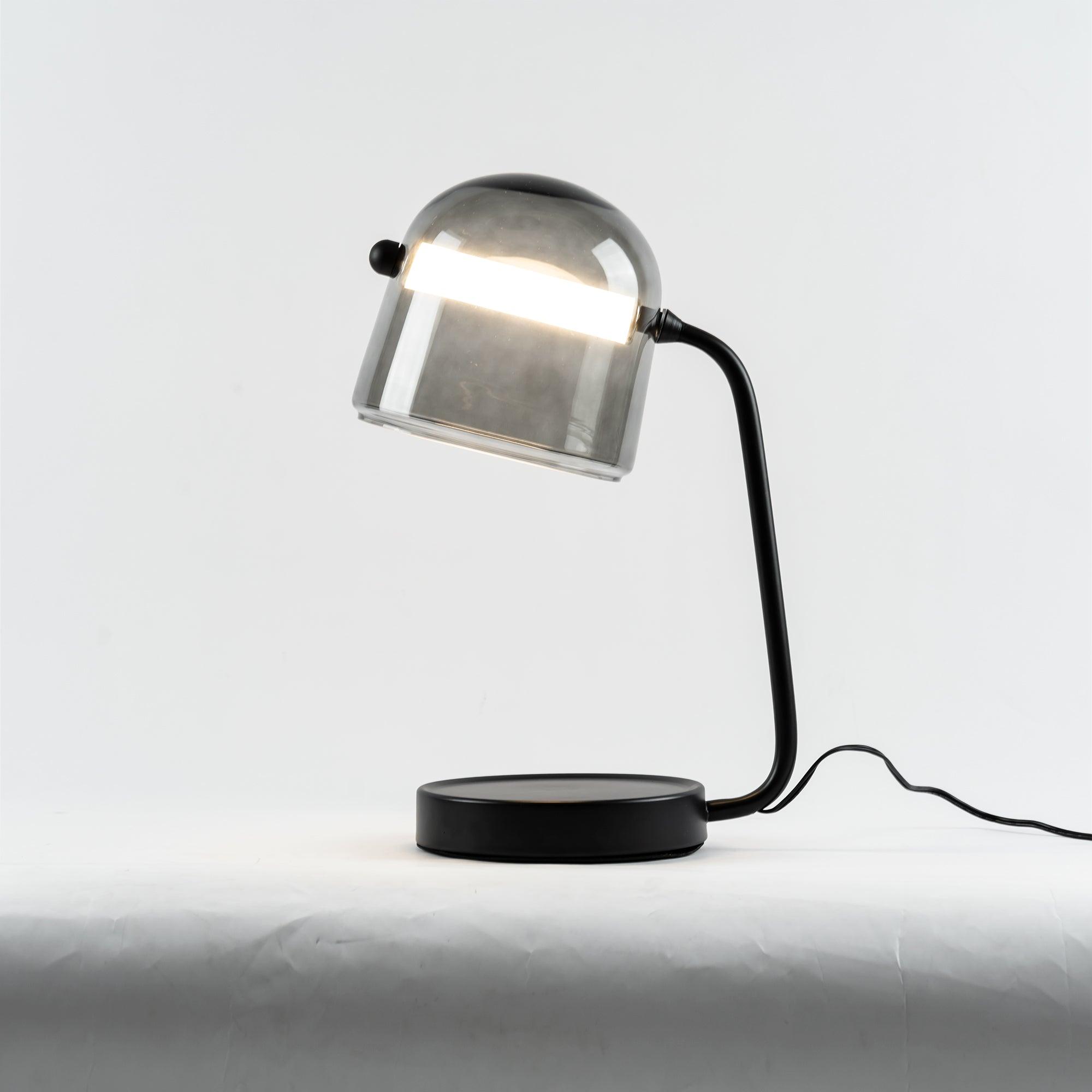 Illuminated Mona lamp on a pale tabletop