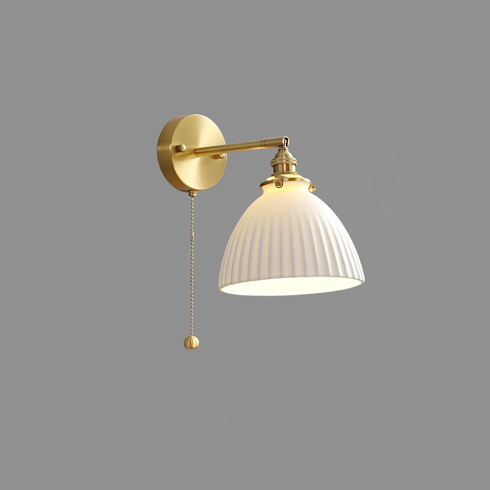 Reverse-angle lit white pleated wall light on grey, with arm extending right and round-ended hanging chain