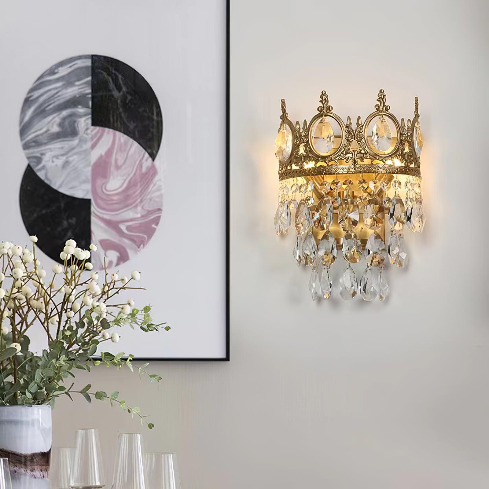 Crystal crown light beside framed artwork