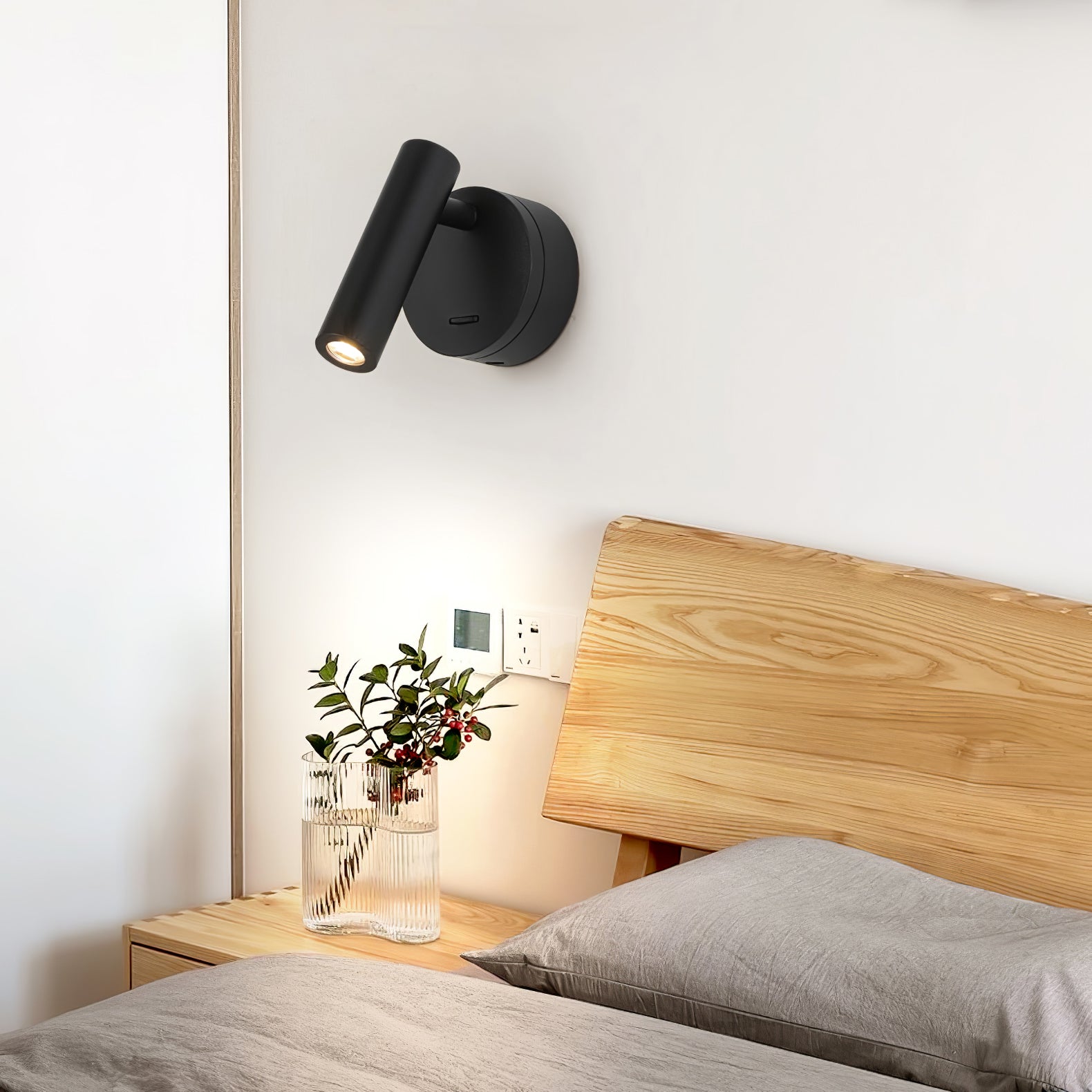 Black spotlight beside a wooden headboard