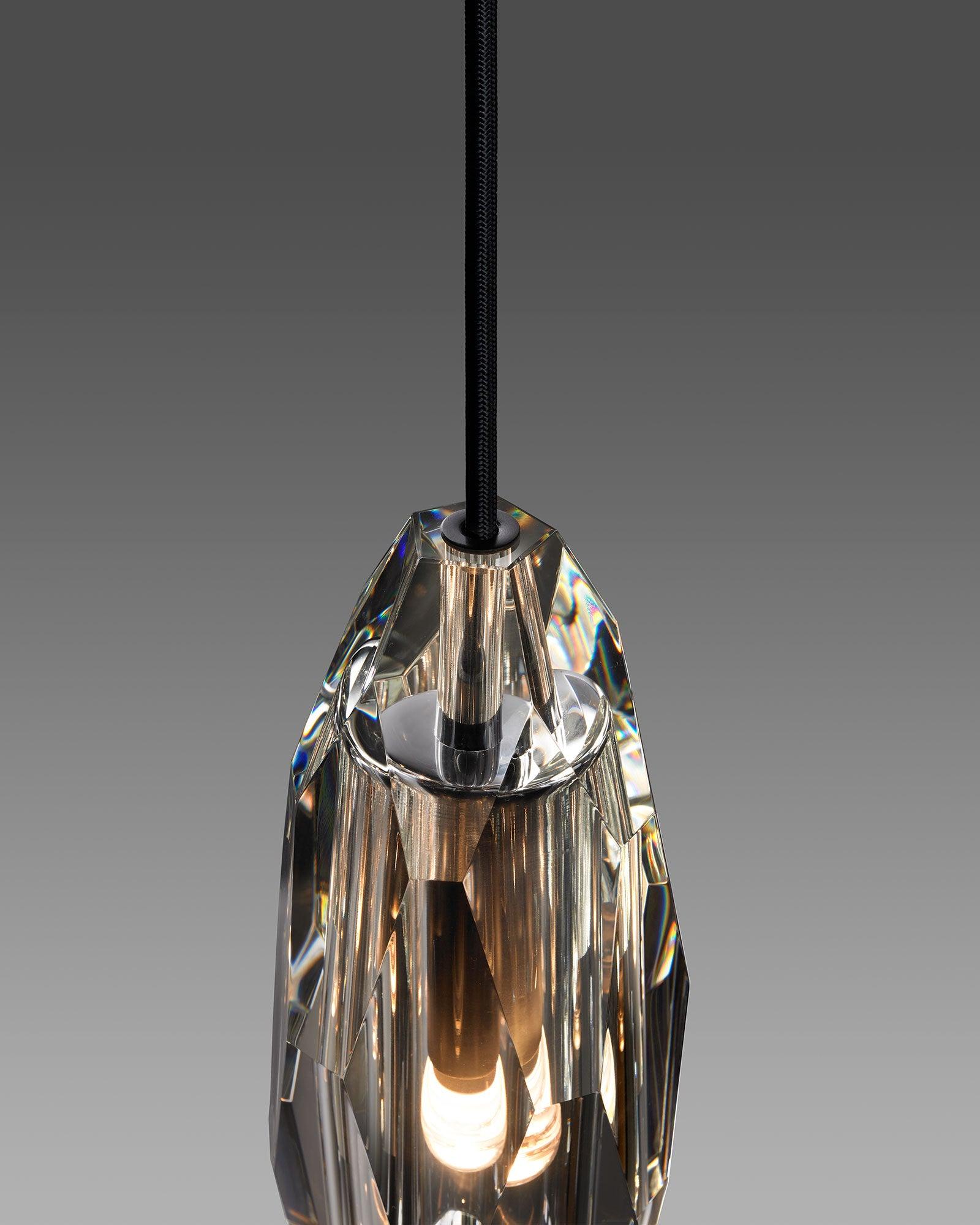Faceted clear crystal around the lit bulb and socket