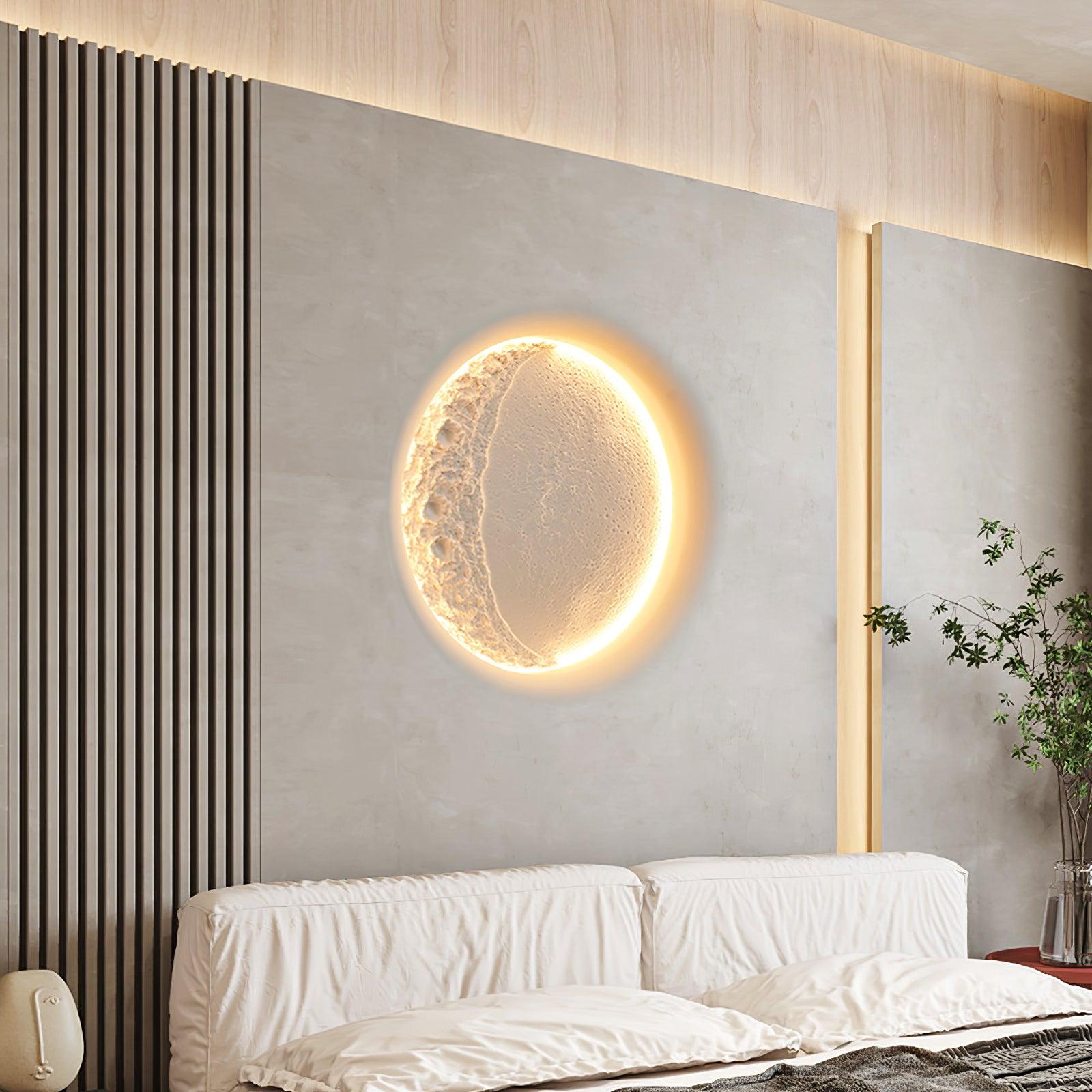 Glowing Gypsum Moon wall light above pale bedhead beside vertical wall slats and tall vase