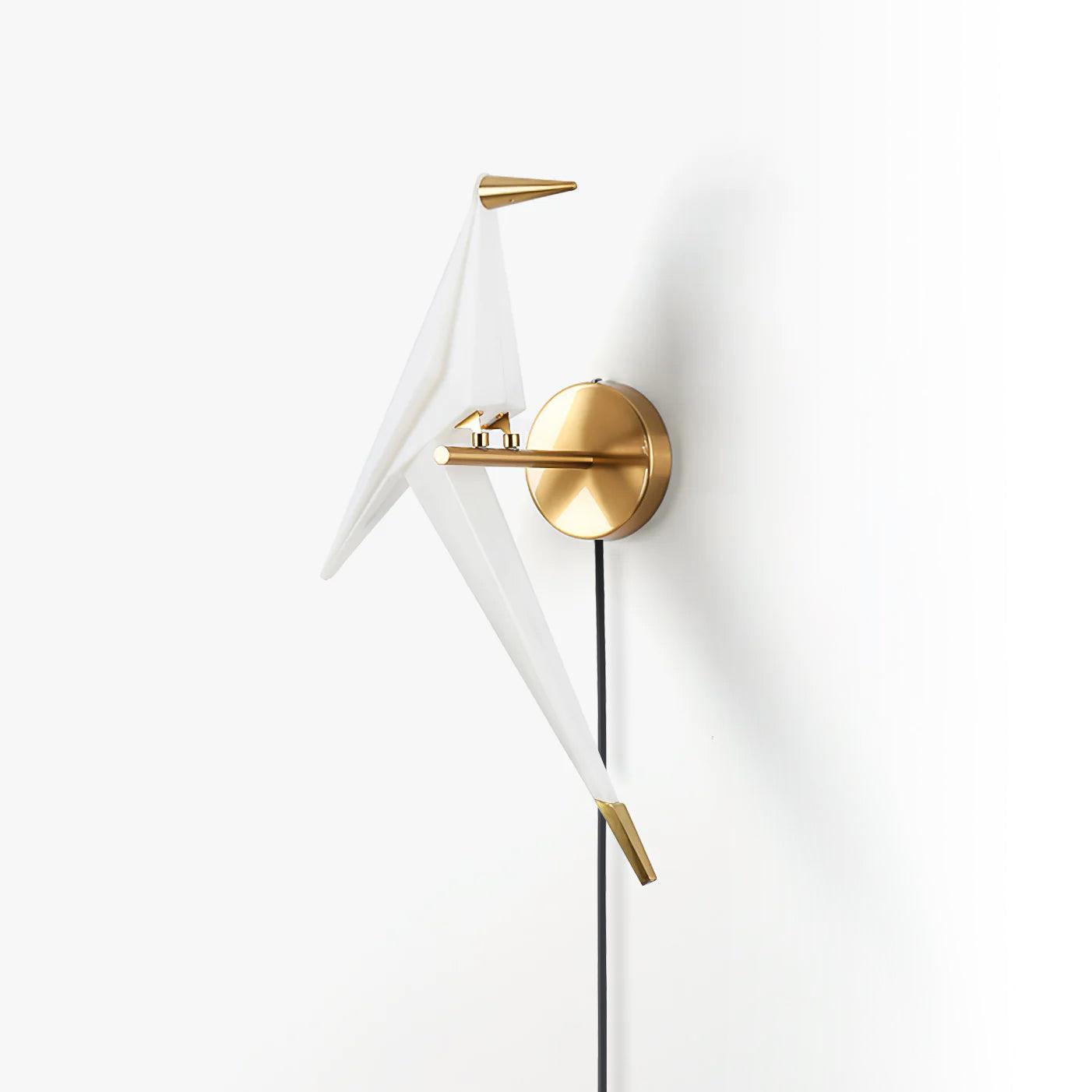 Angled unlit-looking Gold and White bird wall lamp on a round backplate, with a Black cable and long pointed tail