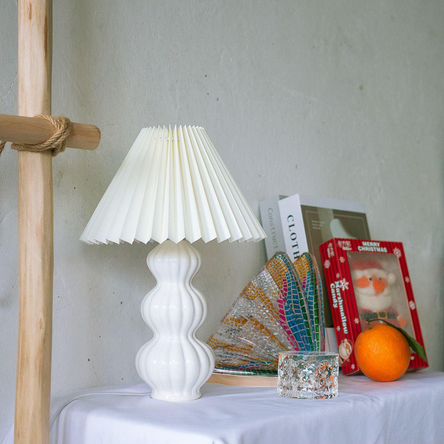 Pale pleated Leo shade with glossy white ribbed base