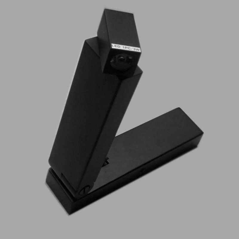 Black folding light opened upward on grey background, showing angular head, unlit lens and LED 1PC/3W label
