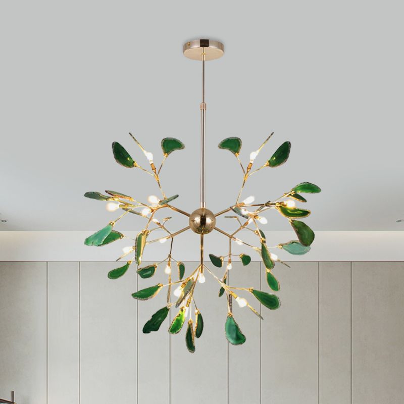 Large green stone-leaf pendant with lit capsule bulbs and central gold-tone sphere above white wall panels