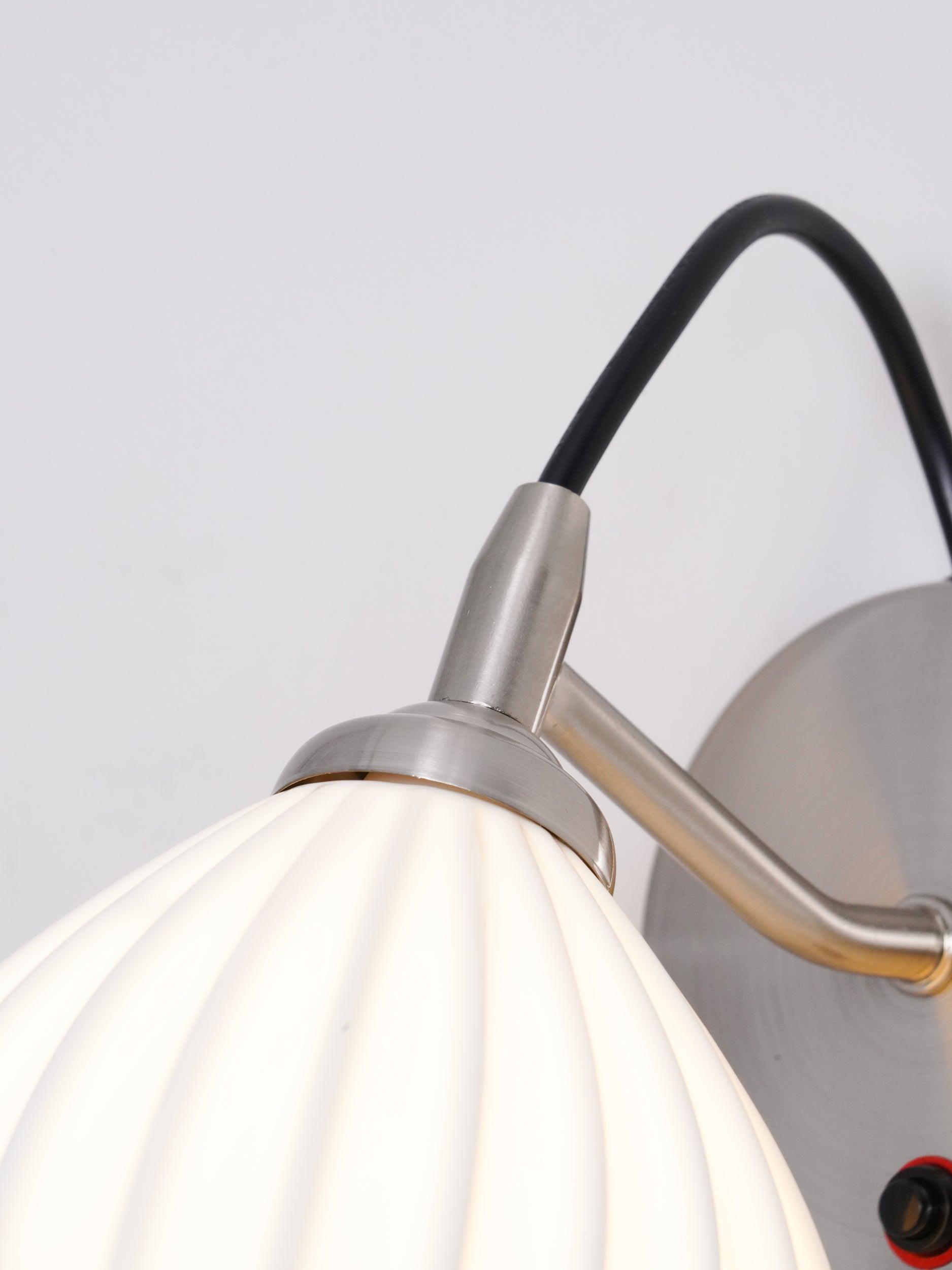 Cord loop and metal holder above the ribbed shade
