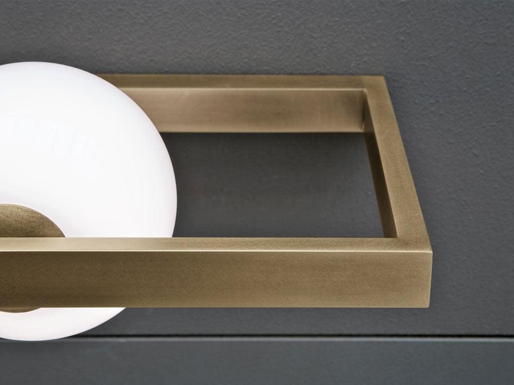 Brushed frame corner beside the glowing glass globe