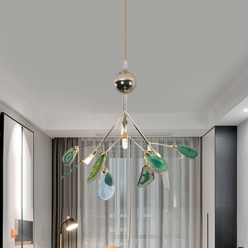 Compact green stone-leaf pendant above a room with curtains, framed artwork and a floor lamp
