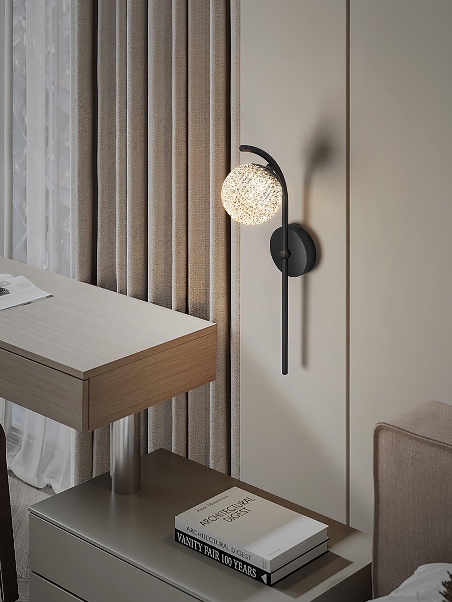 Black curved wall lamp beside a wooden desk