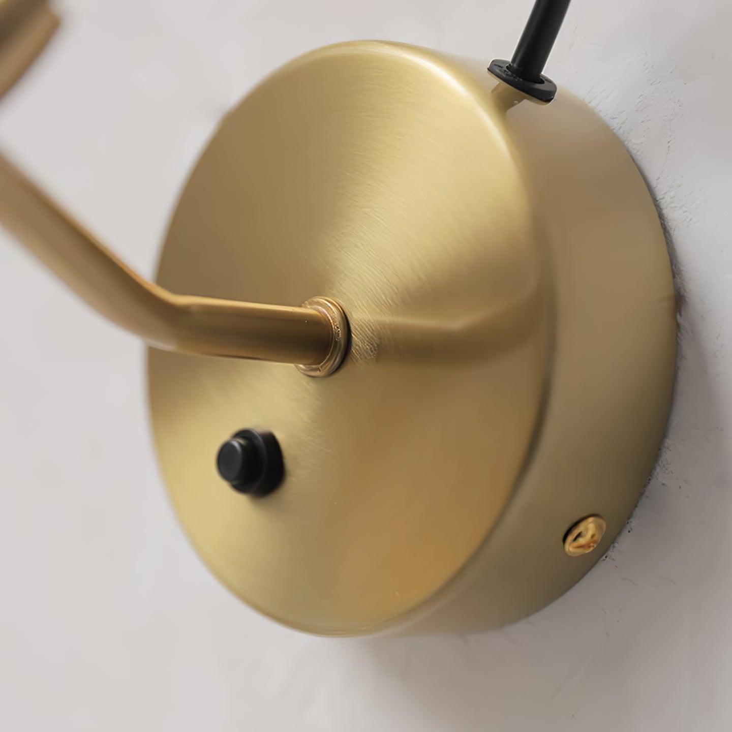 Gold-coloured backplate with a black push button