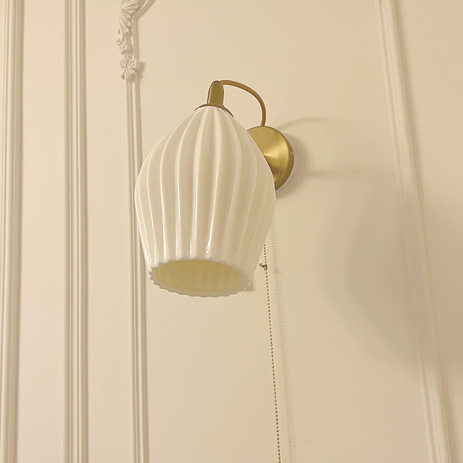 White ceramic wall shade on a pale panelled wall