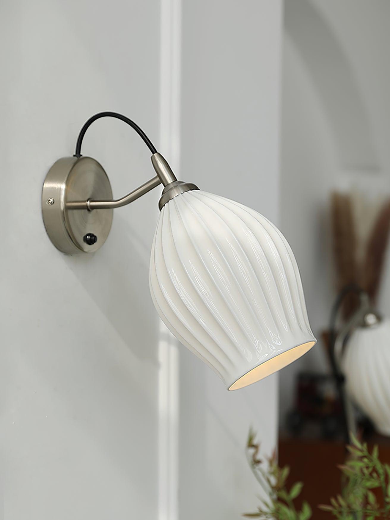 White ribbed shade on a curved sand-nickel arm