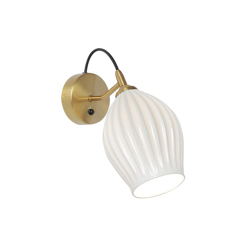 White ribbed ceramic shade on a gold-coloured arm and round plate with a push button