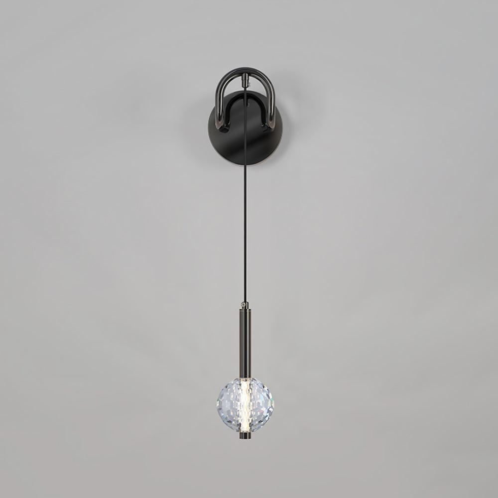 Front view of hanging-globe wall light against grey background, with dark round plate, loop arm and pale blue reflections