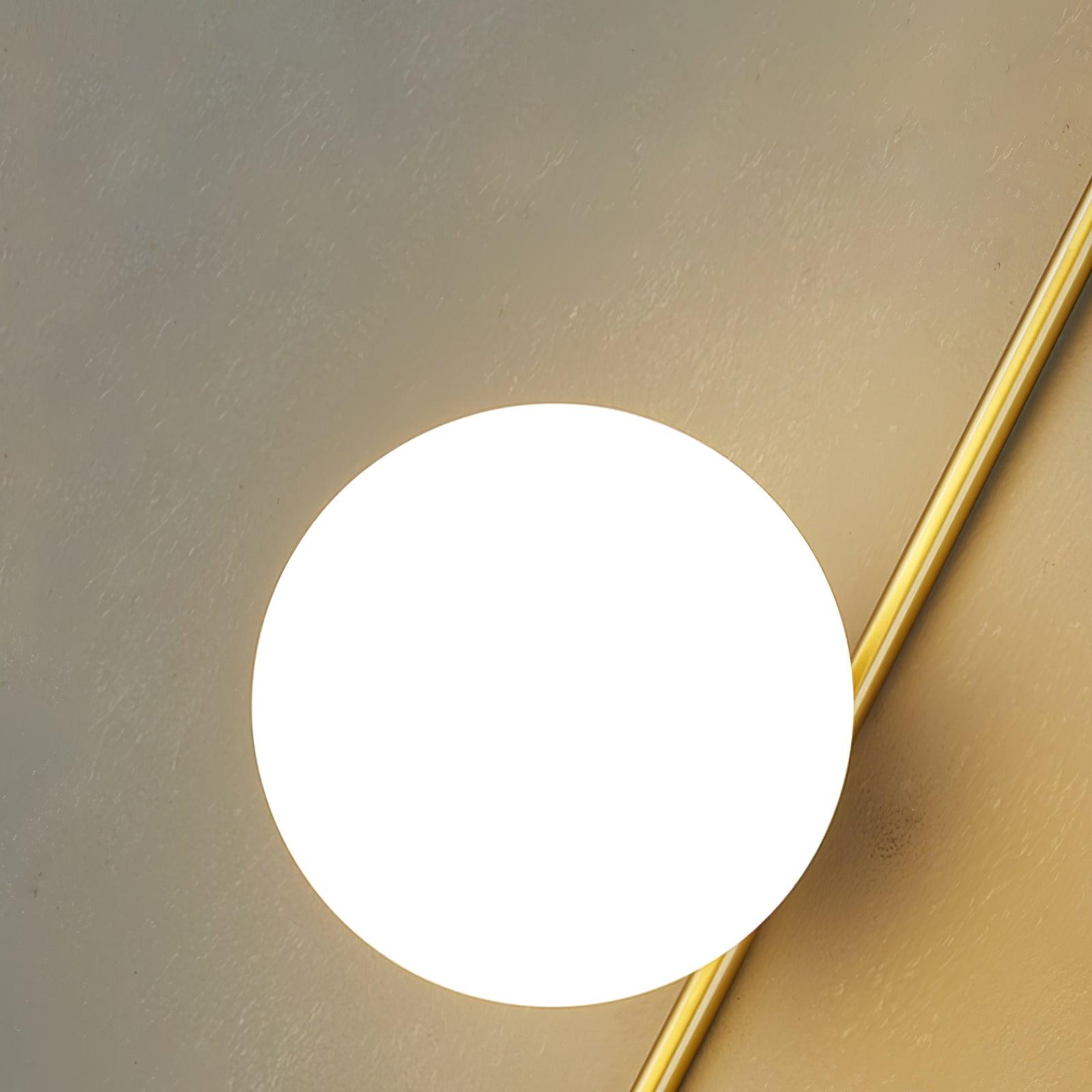 Close-up of White glass globe beside the gold-toned stem