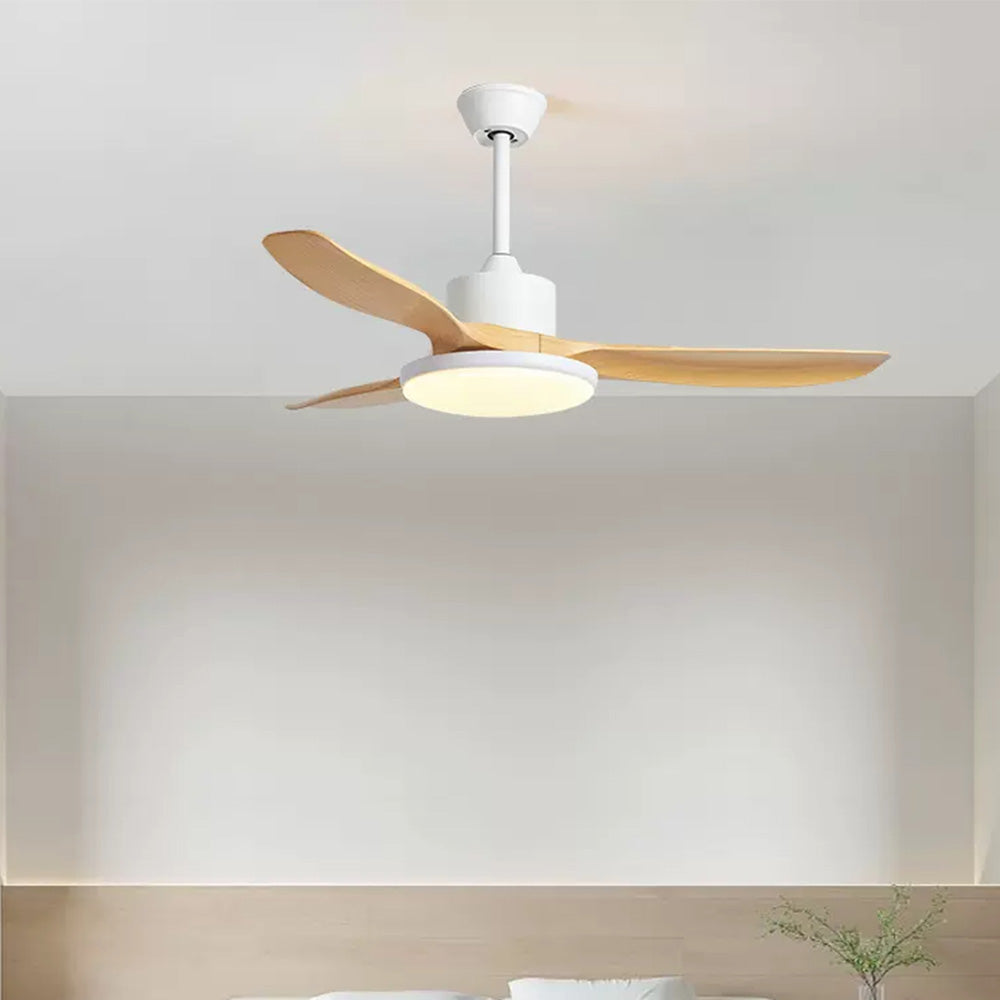 Lit round light beneath a white fan housing and three wood-look blades above indoor seating