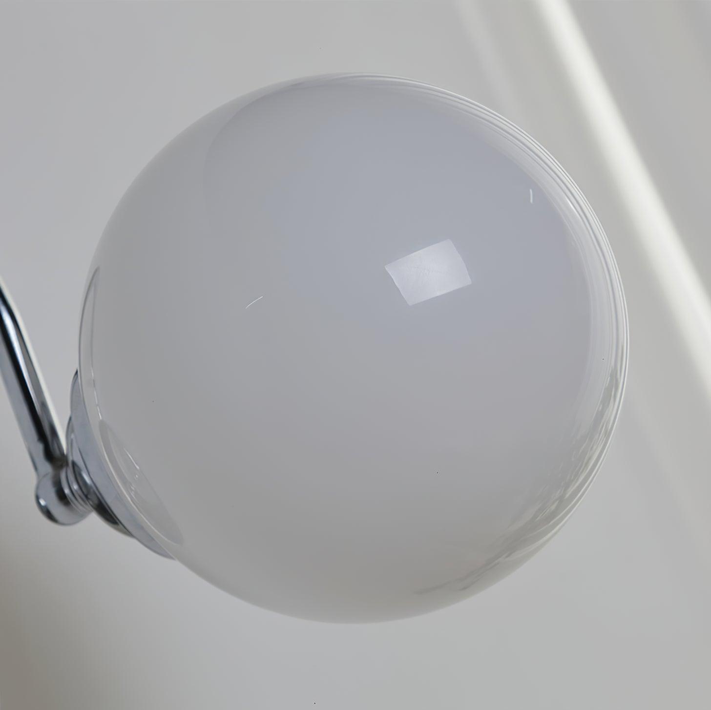 Extreme close-up of smooth glossy white glass globe with a rectangular window reflection and part of its metal fitting