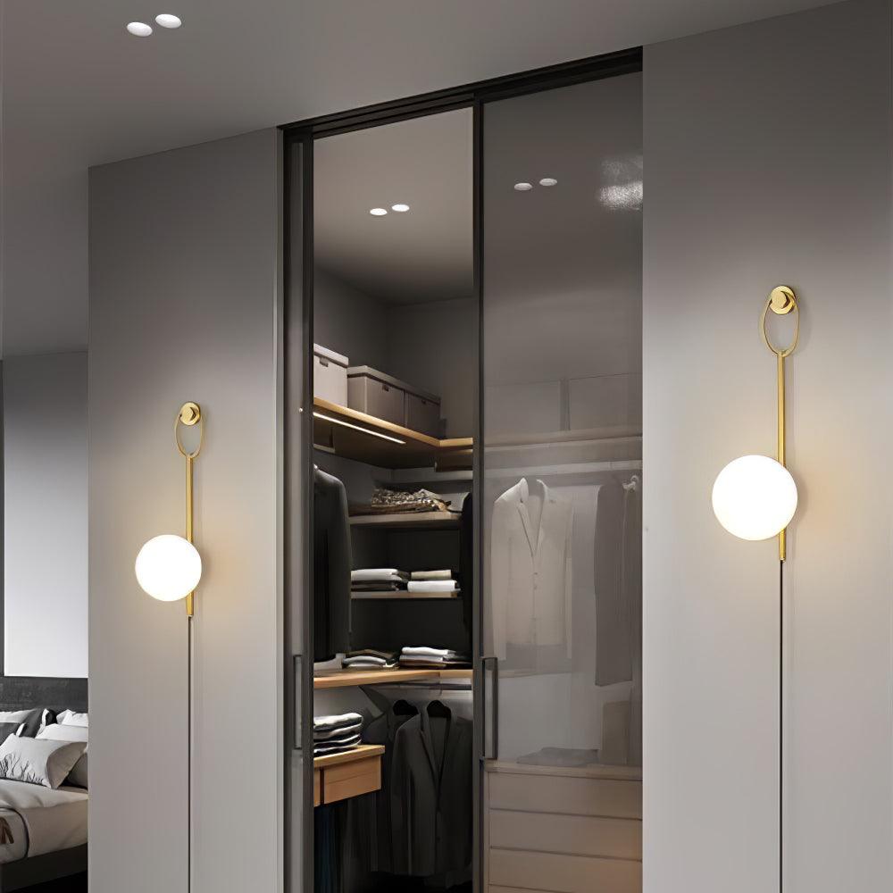 Two globe wall lamps beside a mirrored wardrobe