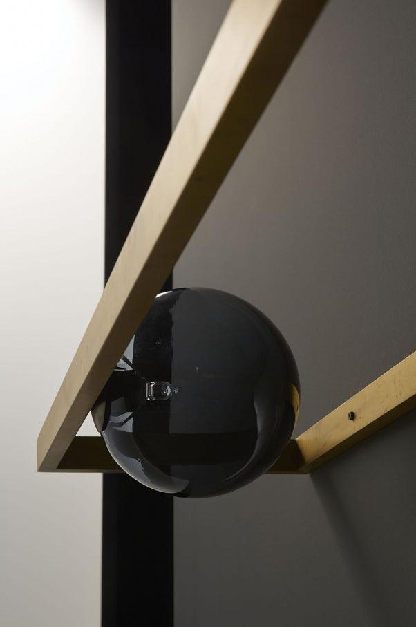 Dark reflective globe within the open frame