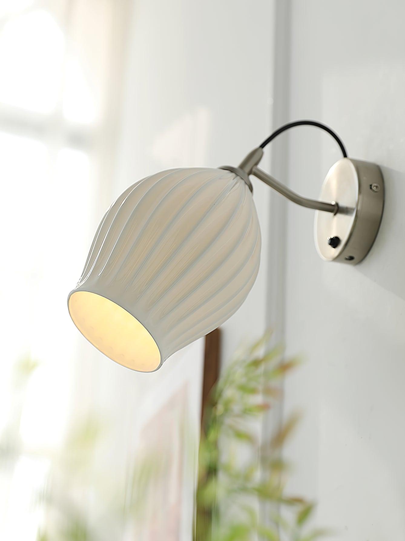 Close room view of a lit ceramic wall shade