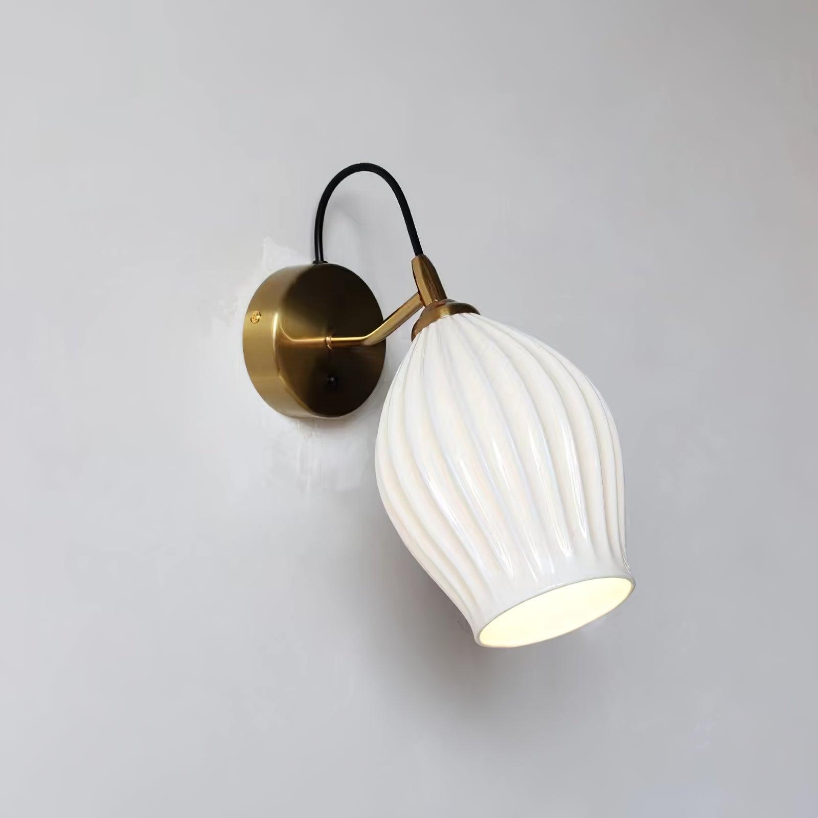 Gold-coloured wall fitting with an angled white shade