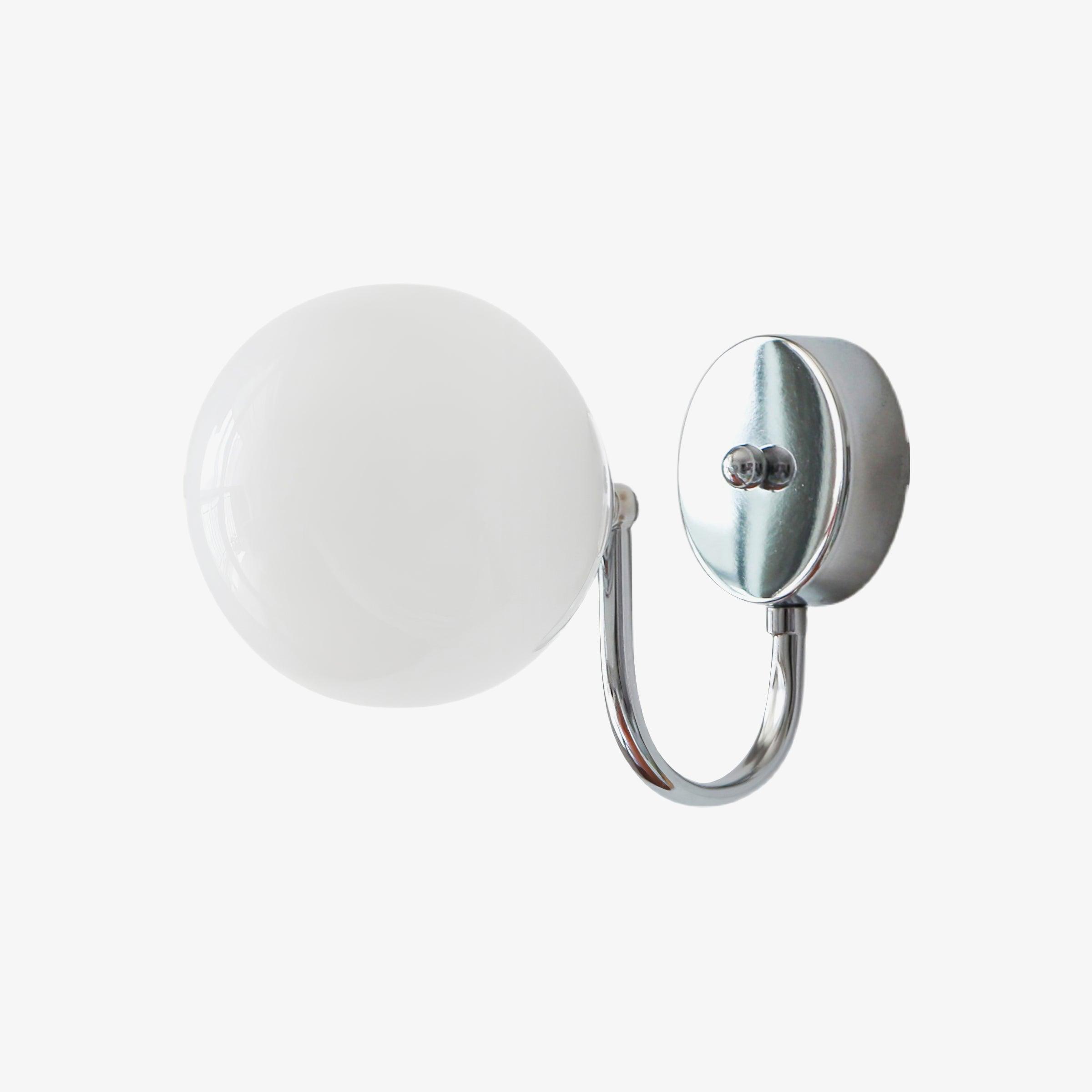 Large isolated Staggered wall light with white glass globe, round chrome-coloured plate at right and lower U-shaped arm