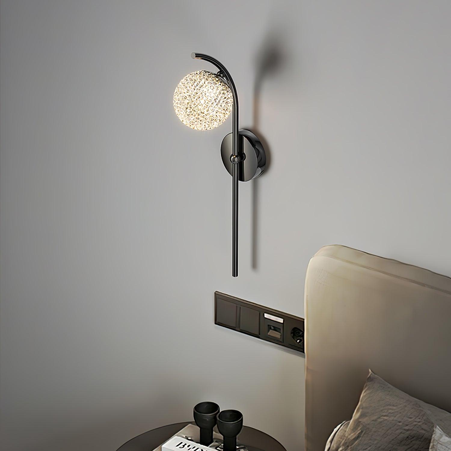 Textured circular wall-light head beside a bed
